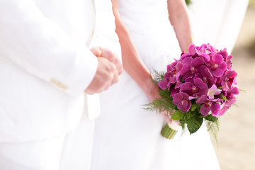 Bride holding bouquet of orchid in wedding ceramony