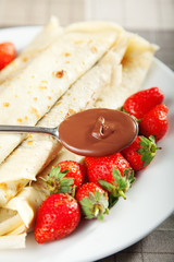 Pancakes with chocolate and strawberries