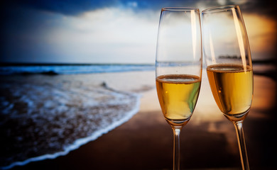 Champagne glasses on tropical beach at sunset - exotic New Year © Melinda Nagy