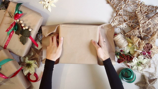 Woman wrapping christmas presents. time lapse