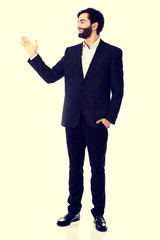 Fototapeta premium Young businessman presenting something.