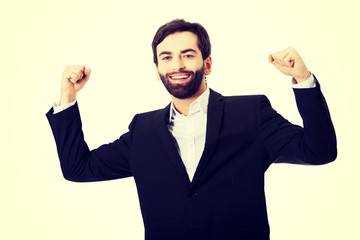 Businessman making fists in a winner gesture.