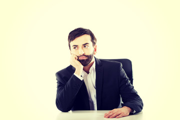 Businessman sitting at the desk.