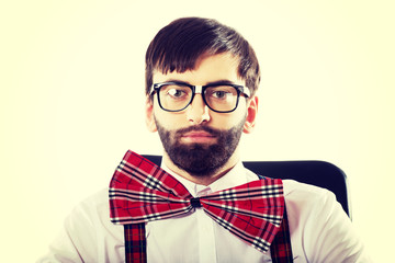 Young old fashioned man sitting on armchair.