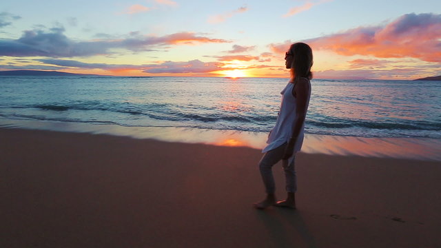 Happy Mature Woman Enjoying a Sunset Walk on the Beach. Vacation Travel Retirement 