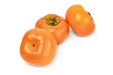 Three persimmons on white