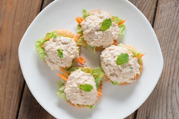Crackers with tuna salad on white palte. Top view.