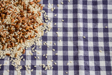  Rice seeds and sesame seeds on a checkered tablecloth. Top