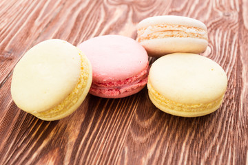 A lot of french colorful cookies on wooden
