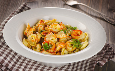 Ravioli pasta with  tomato sauce and fresh herbs.