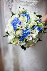 Beautiful wedding a bouquet in hands of the bride