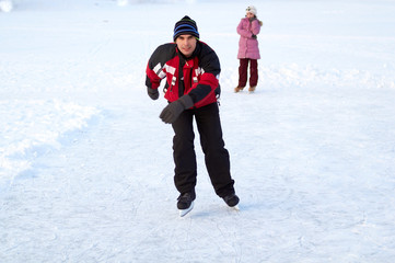 Fototapeta na wymiar Happy family on skating rink outdoors