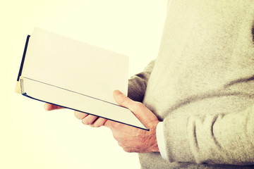 Male hands holding a book