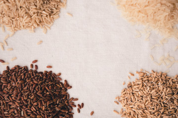 Brown rice,white rice on tablecloth.Top