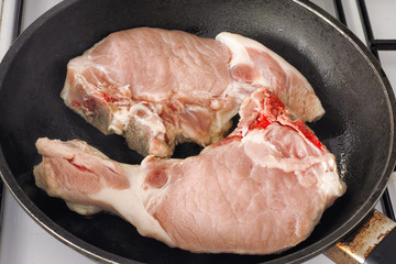Fresh pork meat in a frying pan