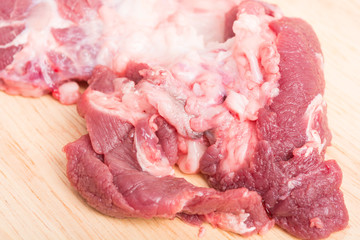 fresh raw beef meat slices on wooden