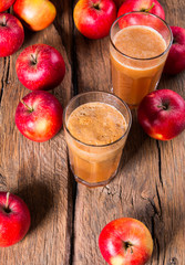 Apple juice and apples on wooden table. Nature apples 
