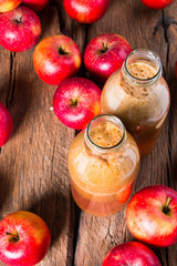Apple juice and apples on wooden table. Nature apples 