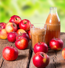 Apple juice and apples on wooden table. Nature apples 