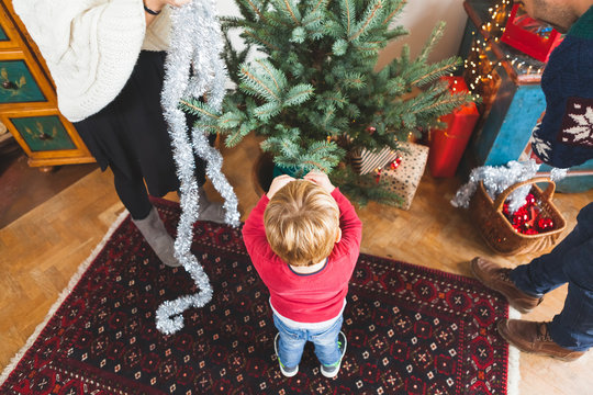 Child with Family Decorating the Christmas Tree
