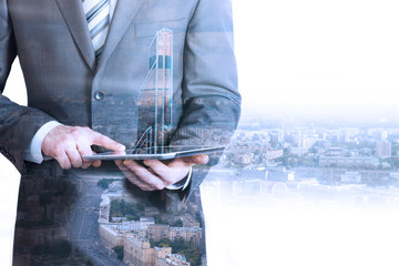 Businessman holding tablet with 3d city model