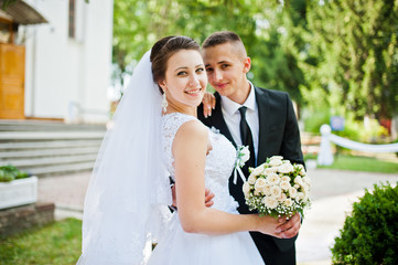 wedding couple with bouquet on hand
