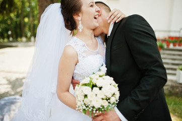 wedding couple with bouquet on hand