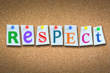 Close-up of word “respect” on cork billboard with sticky notes and colored pins