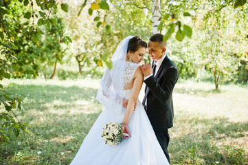 young happy wedding couple on the green park
