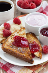 sweet toasts with fresh raspberry, jam and yoghurt for breakfast