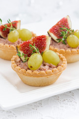 tartlets with liver pate and fruit, closeup vertical