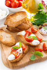 toasts with mozzarella, basil and cherry tomatoes 