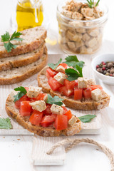toasts with tomatoes and marinated feta, vertical