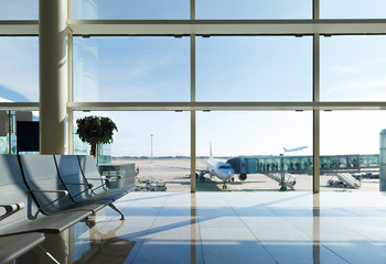 Airport terminal, people going to airplane in background - obrazy, fototapety, plakaty