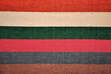 Segment of handmade carpets in bright colors