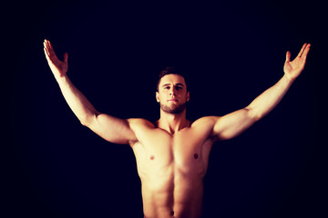 Fototapeta na wymiar Sexy muscular man with hands up.