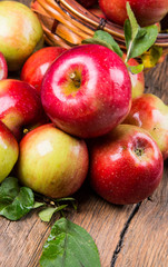 Apples on wooden table over autumn bokeh background