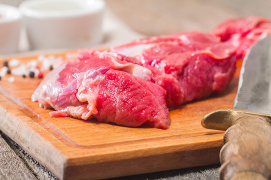 Raw meat  on wooden cutting board
