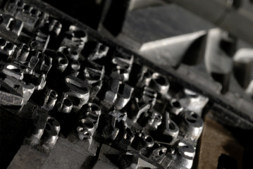 Naklejka premium Metal Lettrpress Types. A background from many historic typographical letters in black and white with white background.