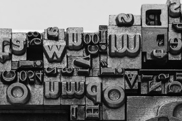 Metal Lettrpress Types.
A background from many historic typographical letters in black and white with white background.
