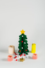 Small green Christmas tree with a golden star decoration isolate