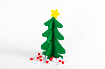 Small green Christmas tree with a golden star decoration isolate
