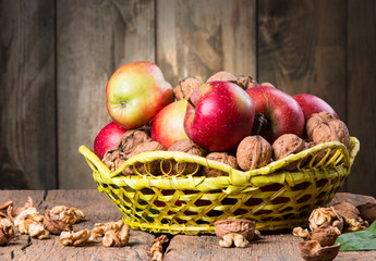 Apples on wooden table over autumn bokeh background
