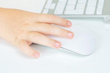 young boy is working with computer mouse