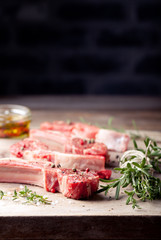 Raw meat, mutton, lamb rack on a wooden background