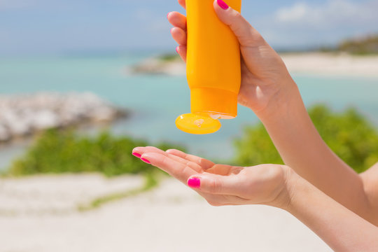 Woman Pouring Sunscreen In Hand