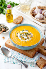 Roasted pumpkin and carrot soup with cream . 