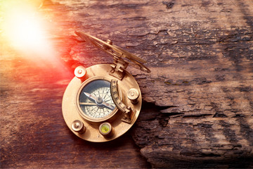 Old sundial with compass on sunny background