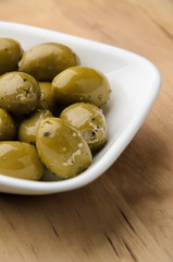 Green olives in white bowl