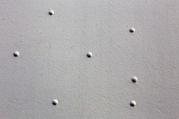 Abstract detailed gray metal wall background texture with seams and rivets